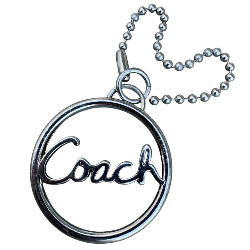 Coach Circular Silver Keychain
Coach Silver Circle Keychain – Timeless Elegance